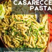 wooden platter of casarecce pasta with asparagus, cheese and peas