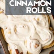 pan of cinnamon rolls covered in icing.