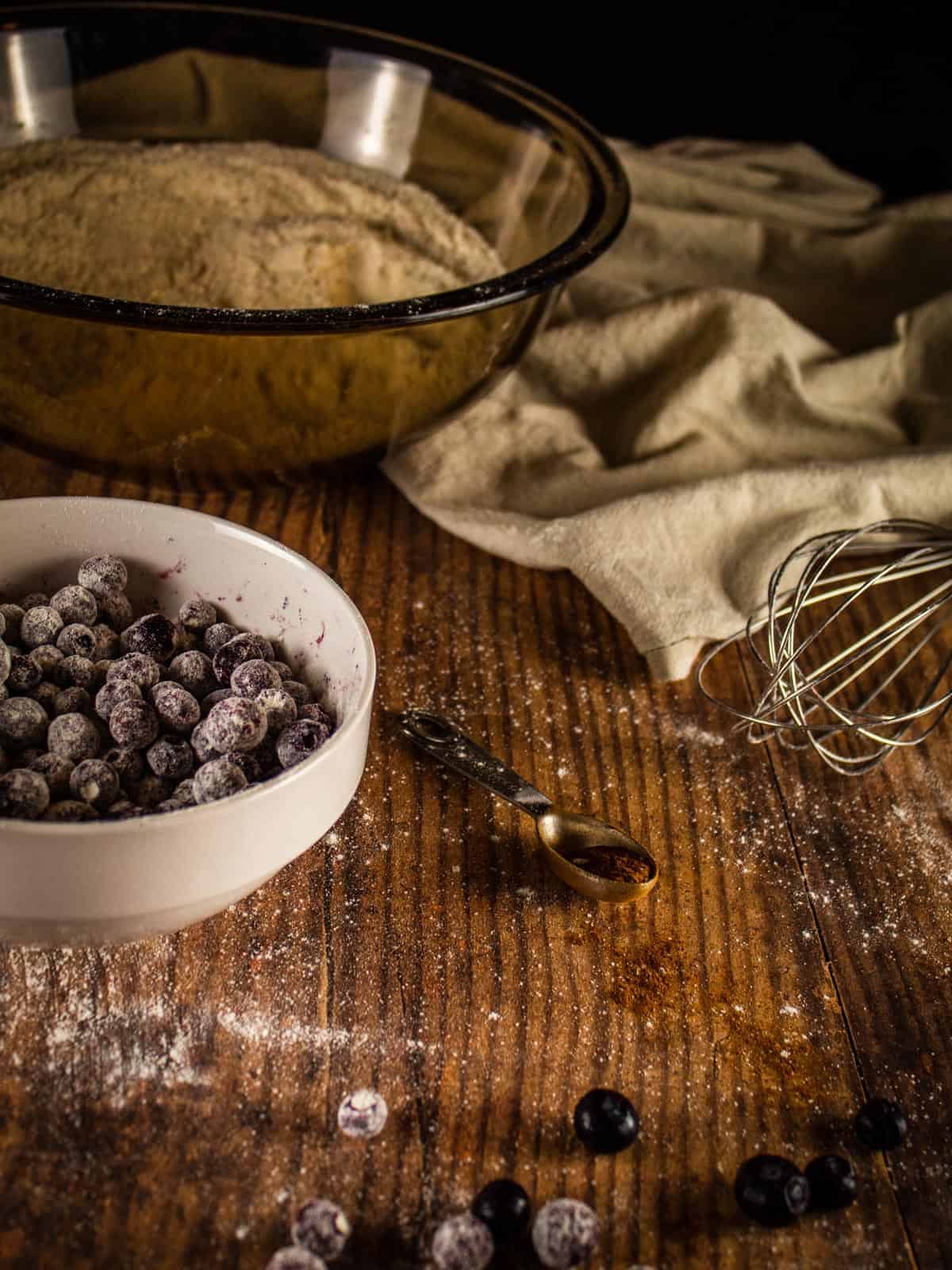 a bowl with blueberries covered in flour 