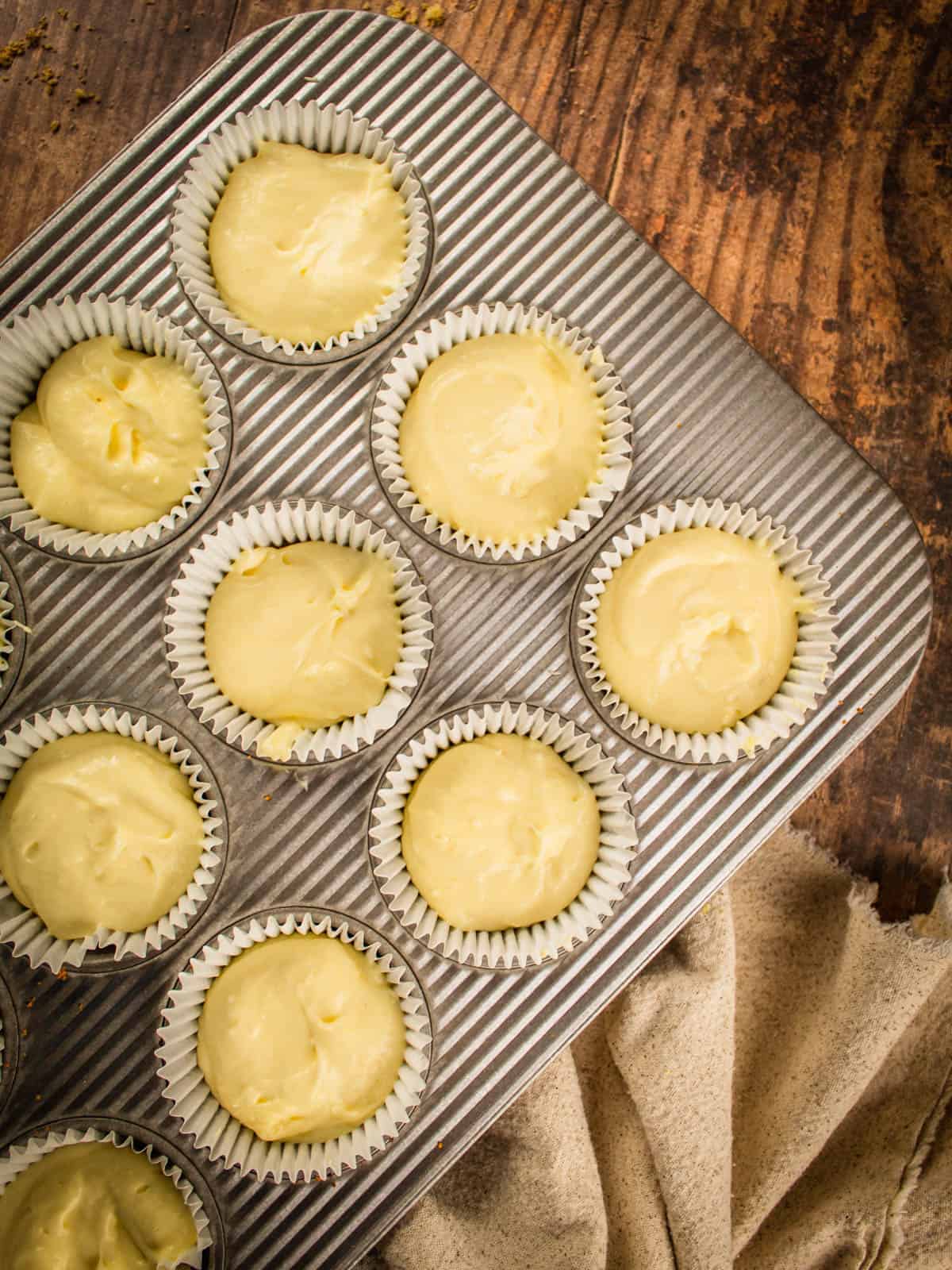 unbaked mini cheesecakes in a muffin pan