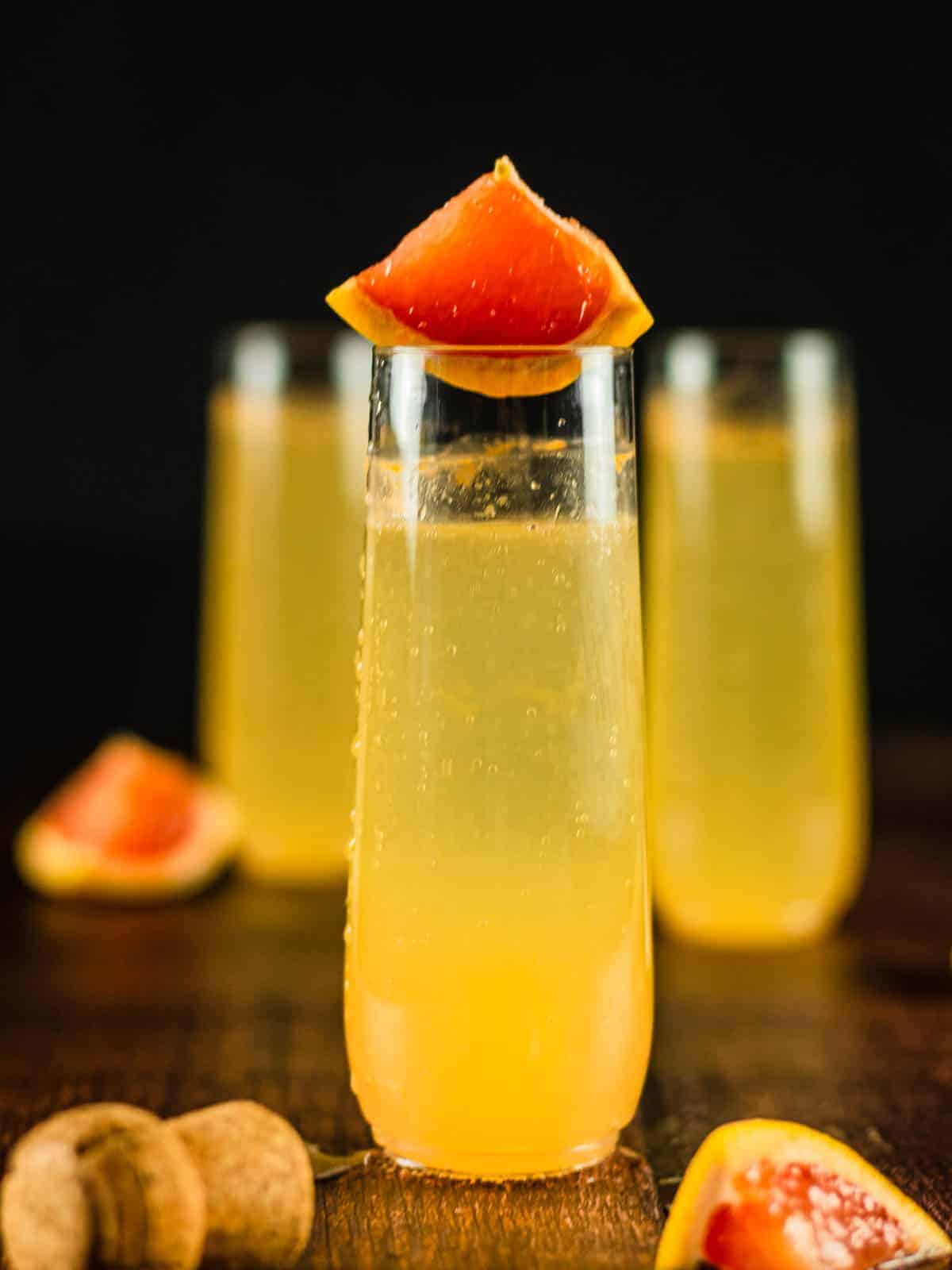 three glasses with cocktail made with grapefruit juice