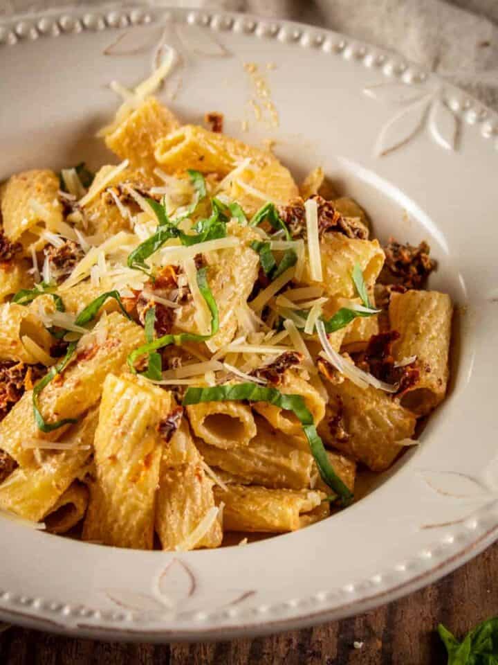 bowl of rigatoni with sundried tomatoes and fresh basil