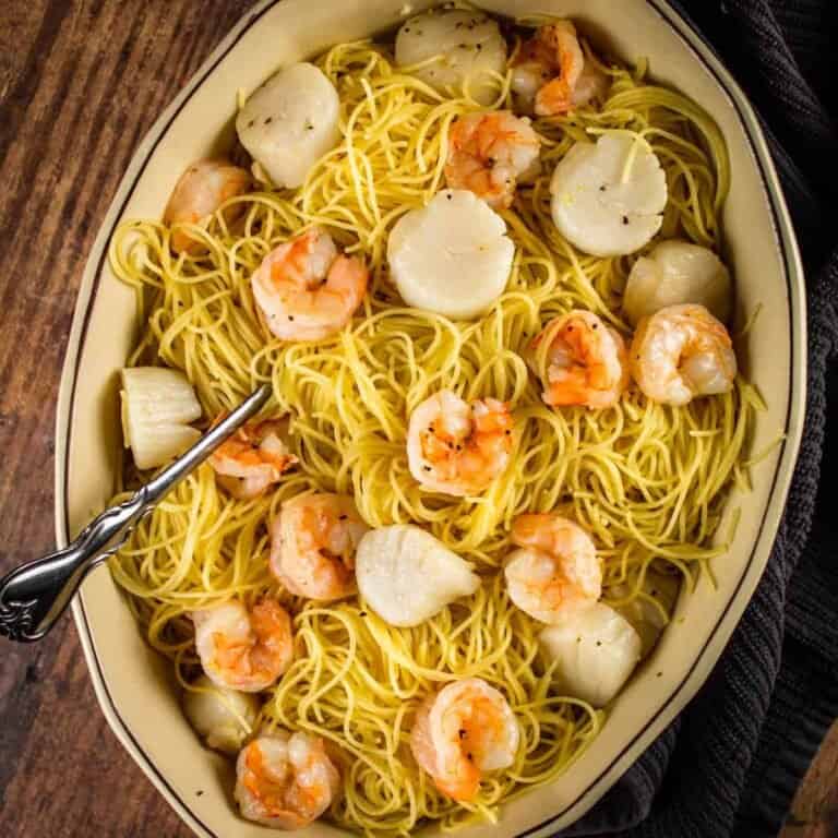 oval dish with pasta, shrimp and scallops