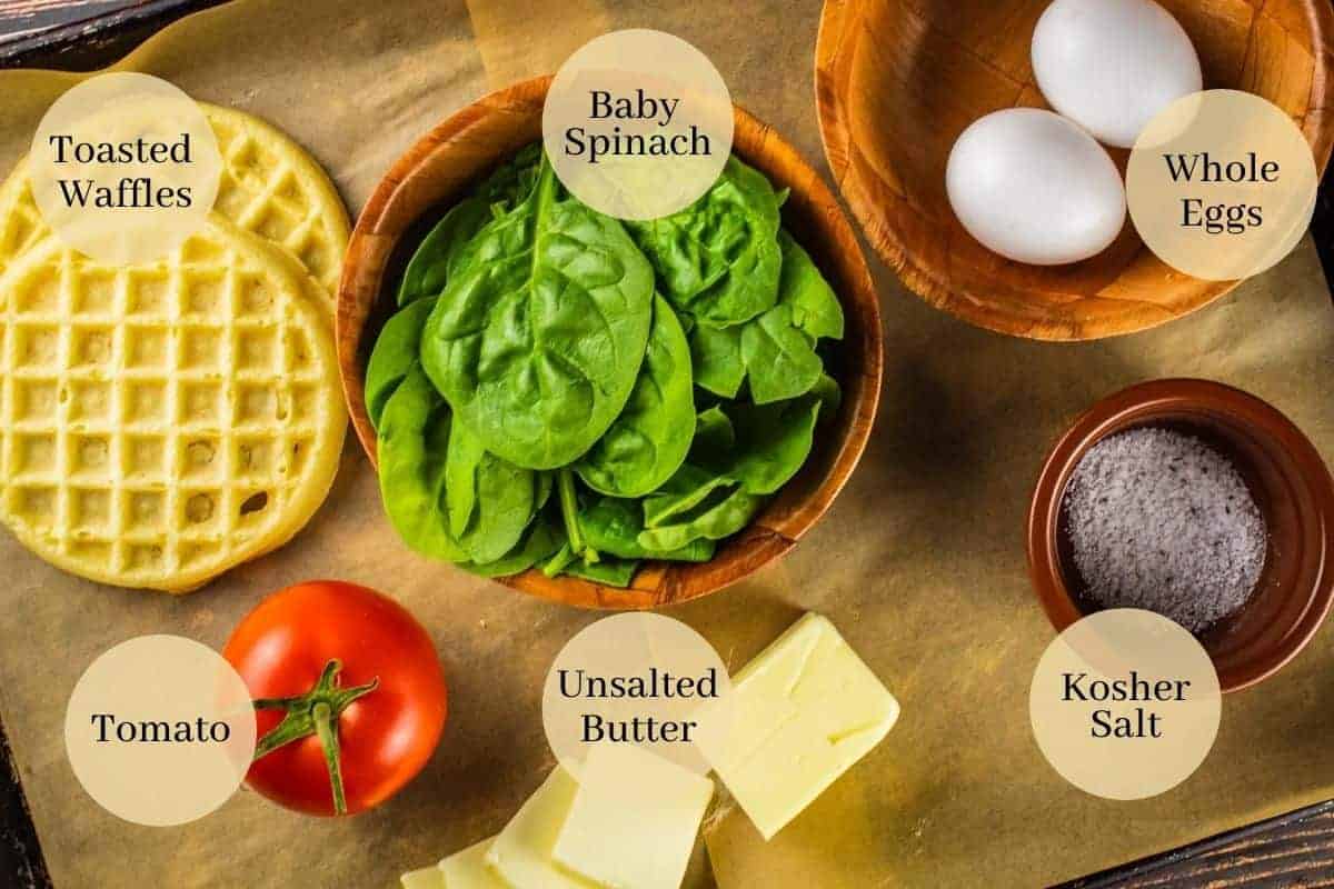 waffles, eggs, spinach, tomato, butter and salt on a sheet pan.