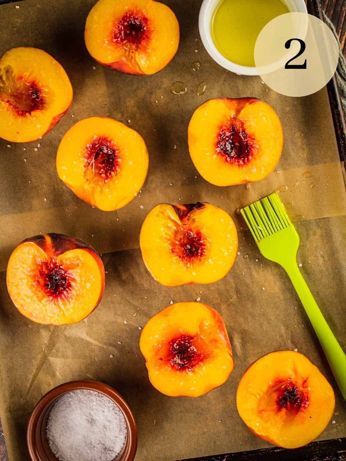 peach halves brushed with olive oil and sprinkled with salt on a sheet pan .