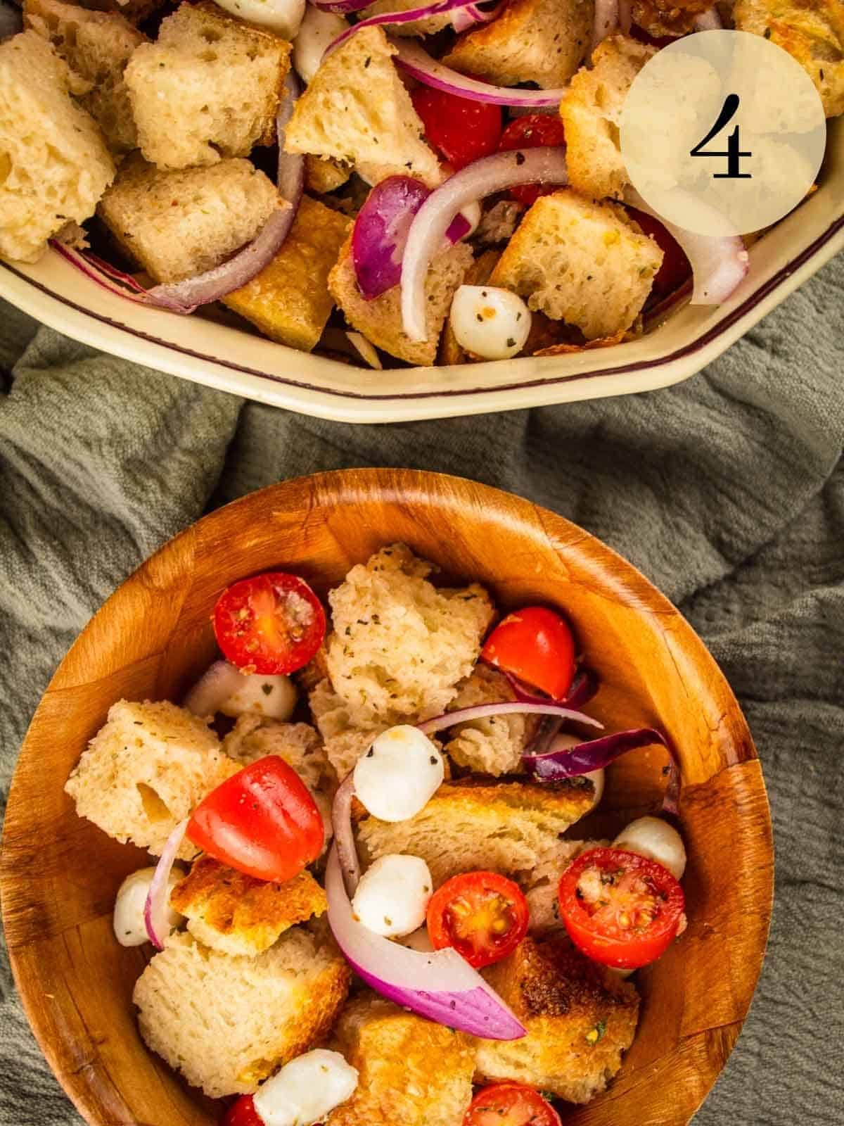 ceramic dish and wooden bowl filled with summer panzanella salad with tomatoes, onion and cheese.