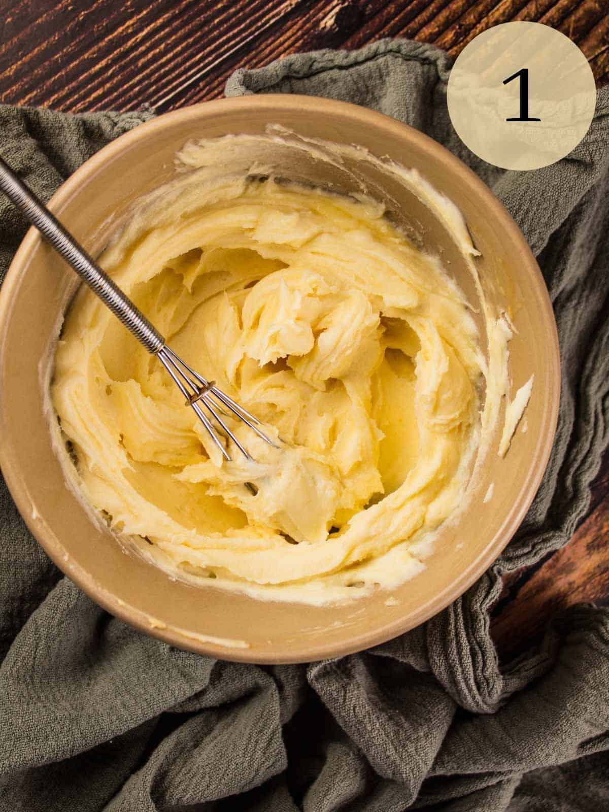 whipped honey mascarpone in a tan bowl with a small whisk.