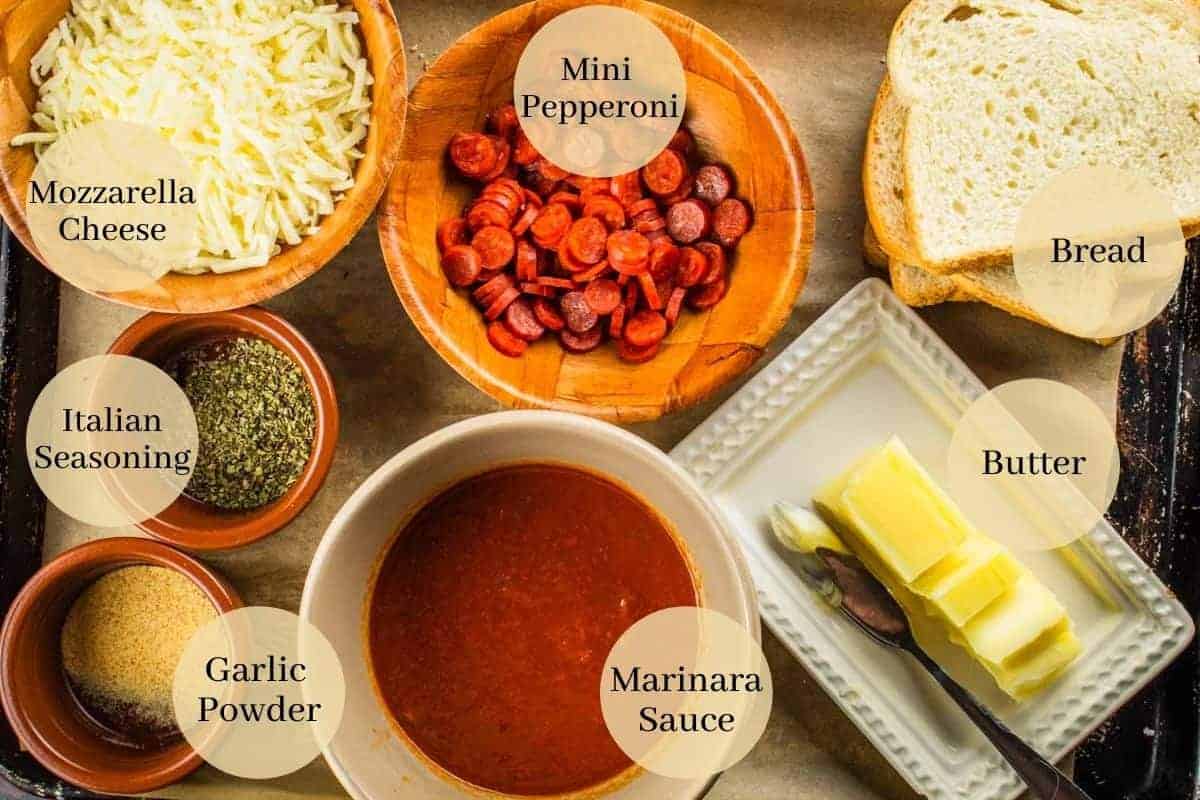 cheese, pepperoni, italian seasoning, garlic powder, marinara, butter and bread on a sheet pan.