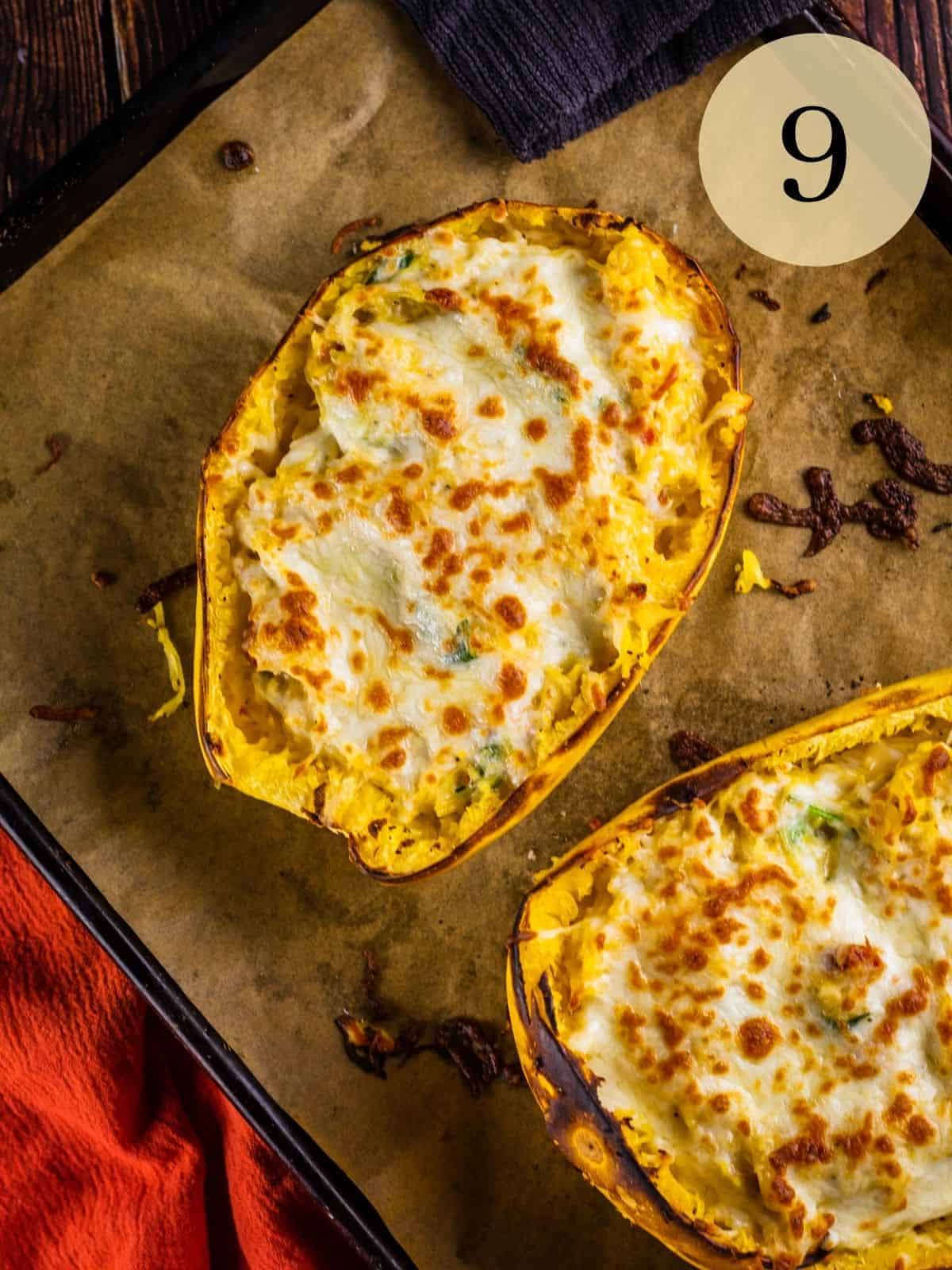 baked spaghetti squash alfredo in shells with melted cheese on top on a sheet pan