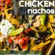 close up shot of baked nachos with chicken and loaded with toppings