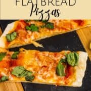 sliced flatbread pizza topped with fresh basil sliced on a wooden tray