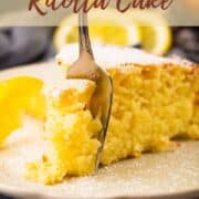 slice of lemon ricotta cake with a fork sticking in it.