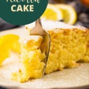 slice of ricotta cake with lemon with fork sticking in it.