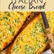 toasted italian bread with garlic cheese butter on a sheet pan.