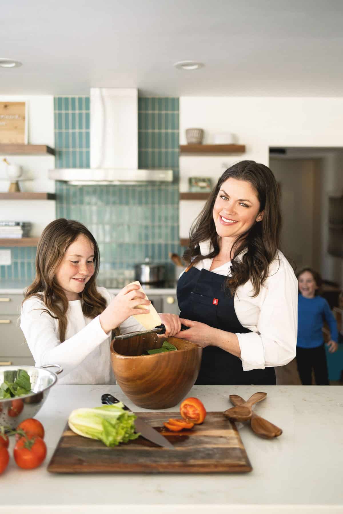 amanda scarlati in the kitchen with a girl and boy making a salad.