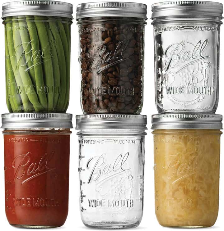 set of size pint sized mason jars, some filled, some empty.