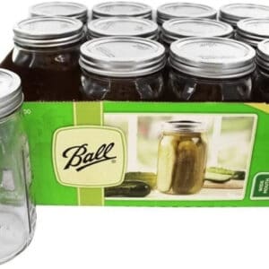 box of quart ball mason jars with one outside of the box.