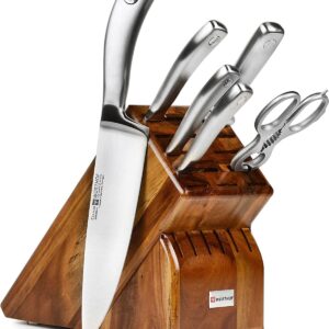 set of silver wuhstof knives in a knife block with one knife outside of it.