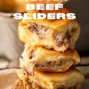 roast beef sliders stacked on top of each other.