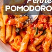 fork in a bowl of penne pomodoro.
