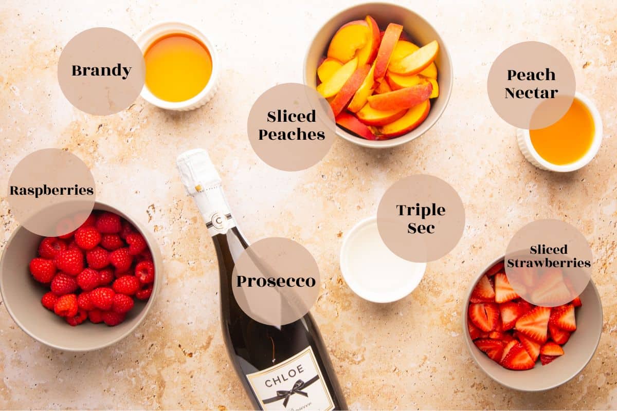 rapsberries, sliced strawberries and peaches, peach nectar, bottle of prosecco, brandy and triple sec.