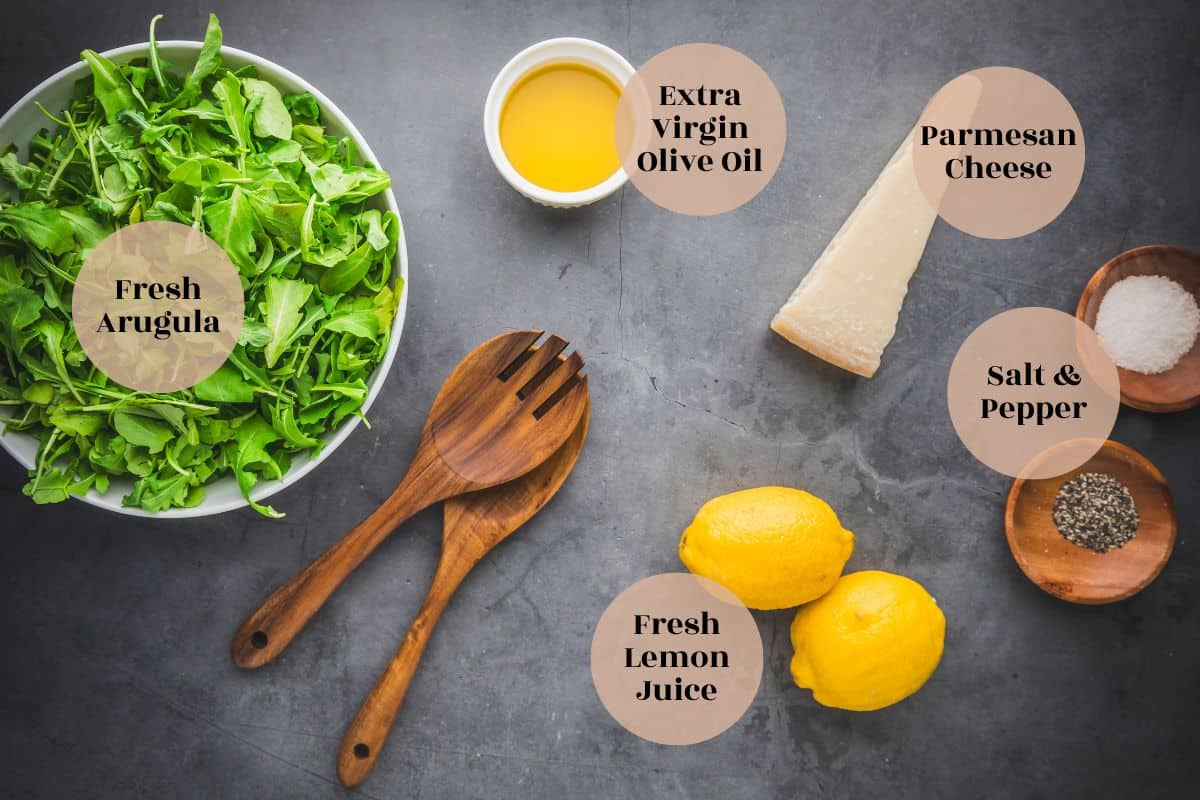 arugula, extra virgin olive oil, wedge of parmesan, two lemons and dishes of salt and pepper.