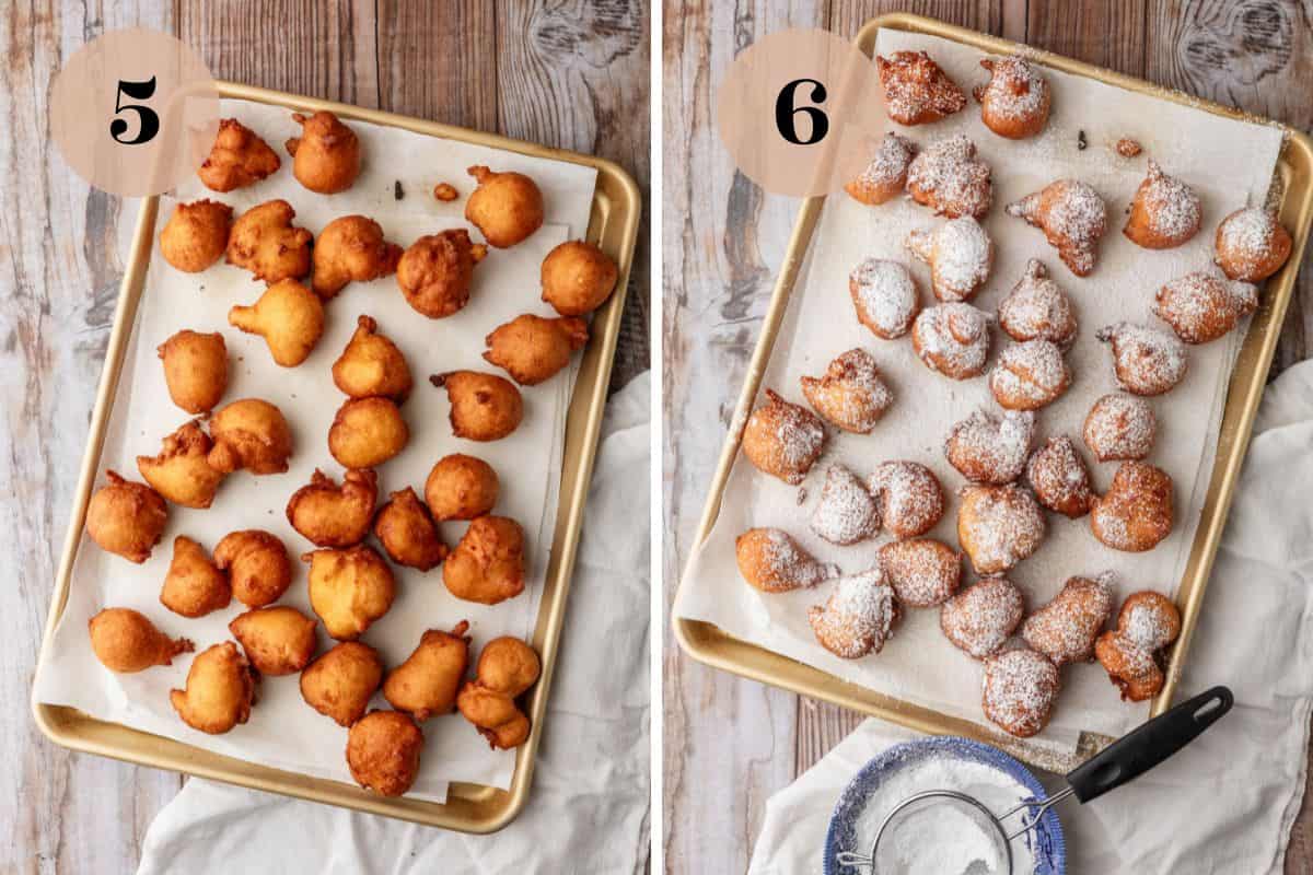 fried zeppole donuts on a sheet pan lined with paper towels and zeppole sprinkled with powdered sugar.