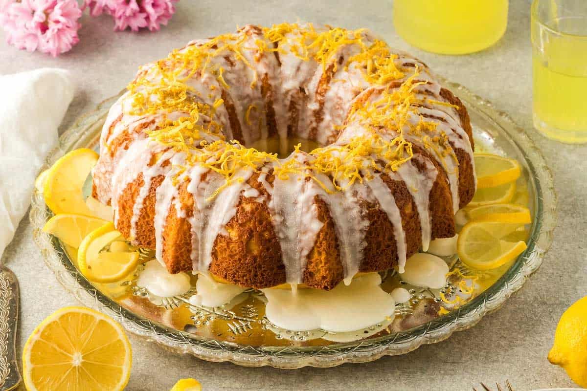 limoncello bundt cake topped with icing and lemon zest.