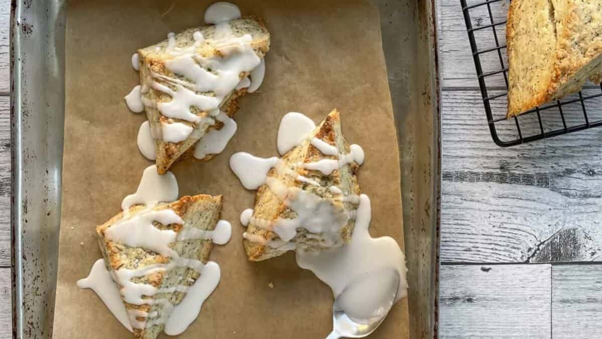 scones on a sheet pan drizzled with glaze.