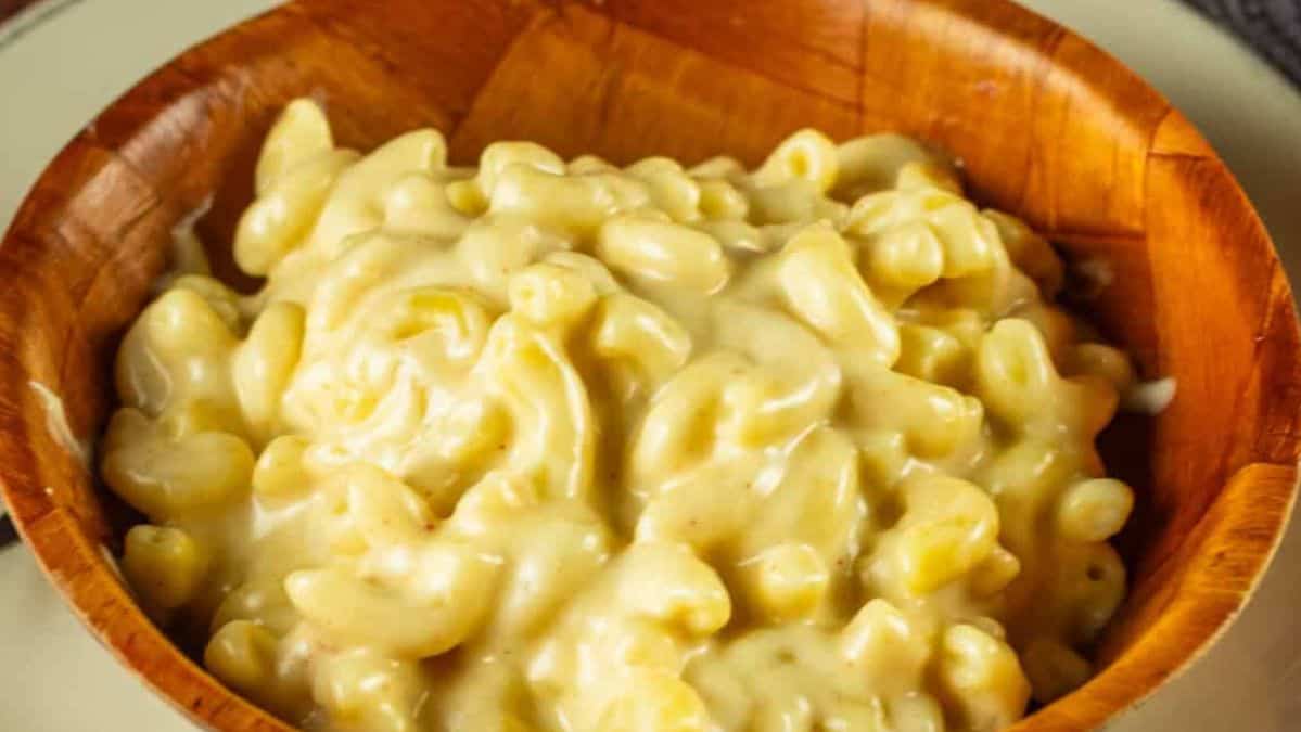 white cheddar macaroni and cheese in a wooden bowl.