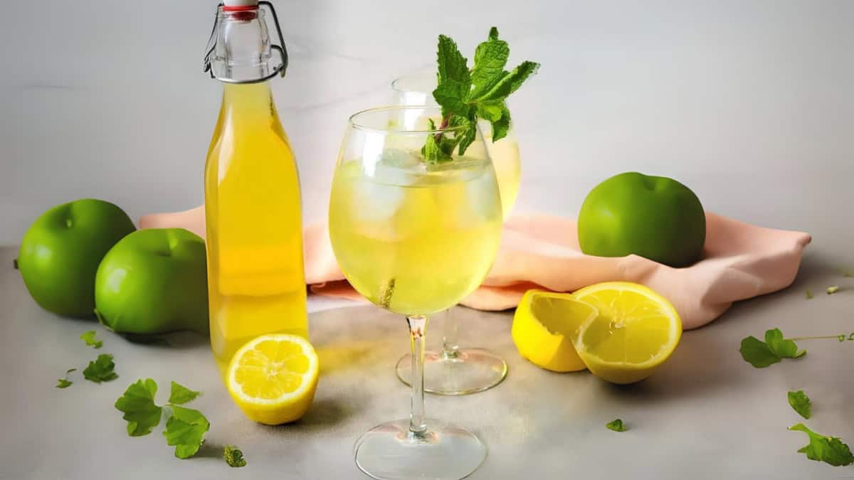 limoncello spritz in a wine glass garnished with fresh mint.