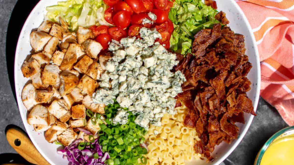 large bowl with salad toppings all sectioned out.