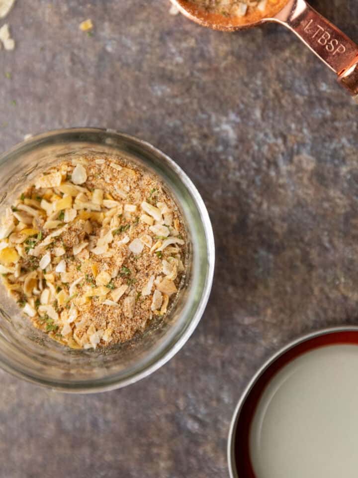 Seasoning mix in a mason jar and in a tablespoon.