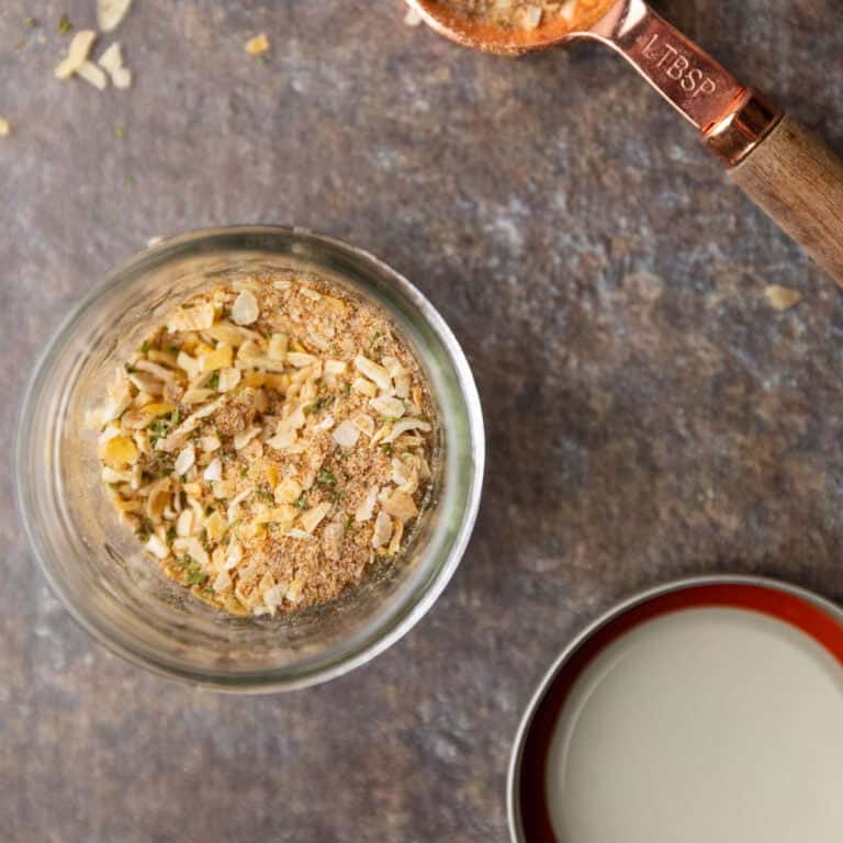 Seasoning mix in a mason jar and in a tablespoon.