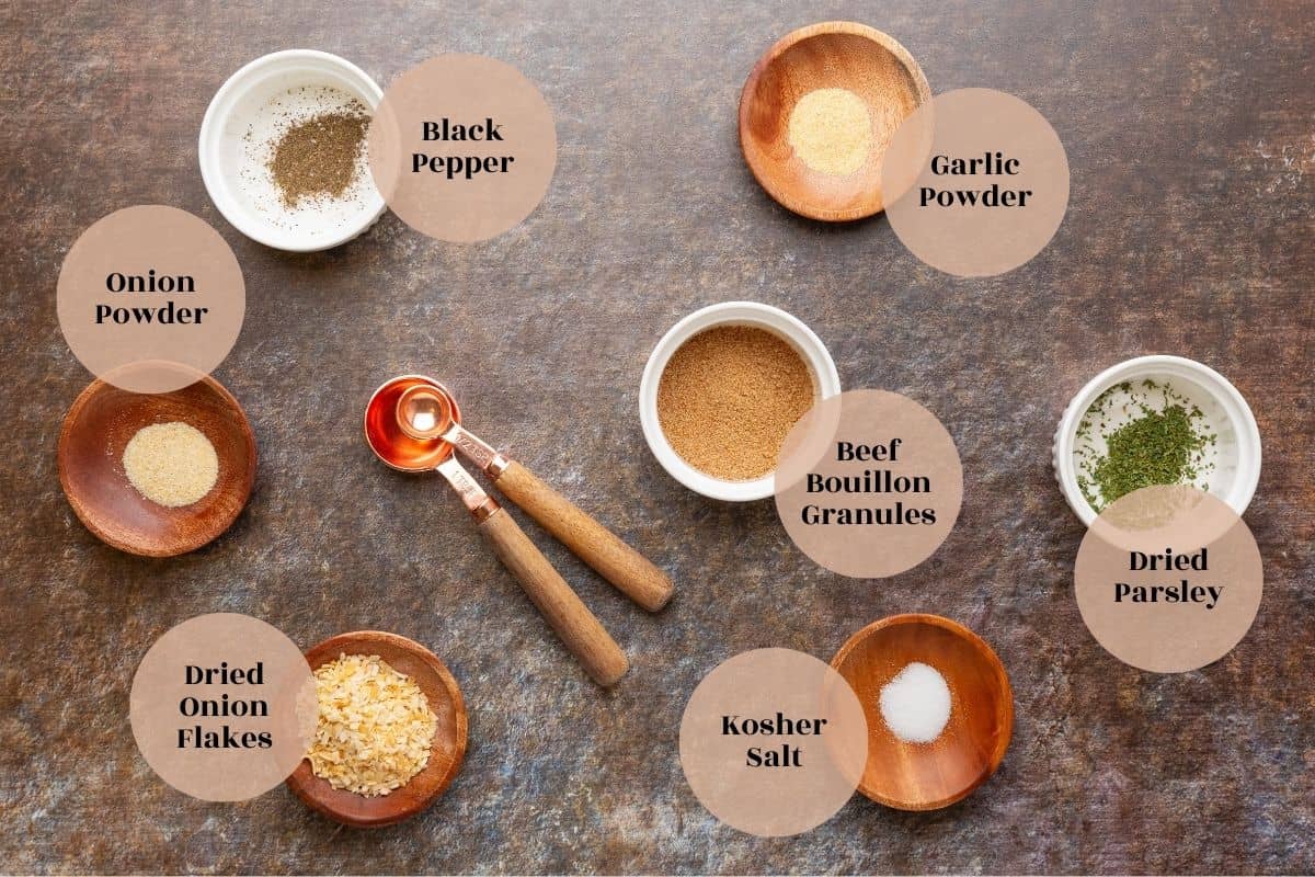 dehydrated onion flakes, garlic powder, onion powder, beef bouillon granules, salt, pepper, and dried parsley in little dishes on a table.