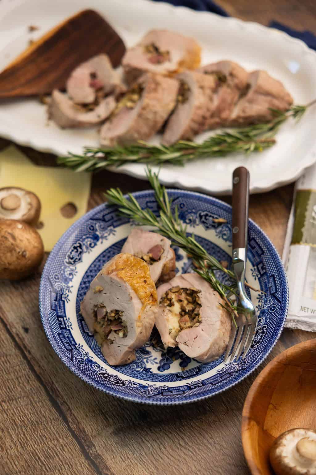 Roasted stuffed tenderloin slices on a plate. 